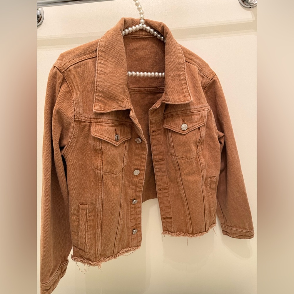 Tan denim jacket with cut hem!